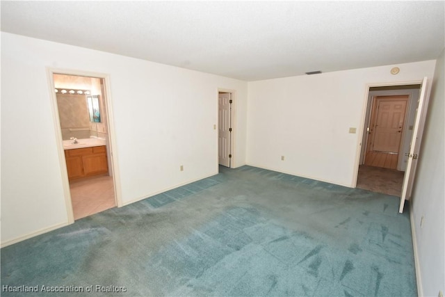 carpeted spare room featuring sink