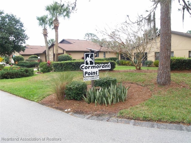 community sign featuring a lawn