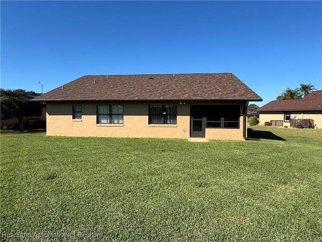 rear view of property featuring a yard