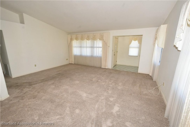 unfurnished living room with light carpet