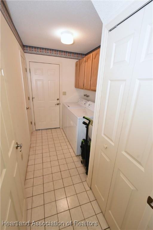 laundry room featuring cabinets, separate washer and dryer, and light tile patterned floors