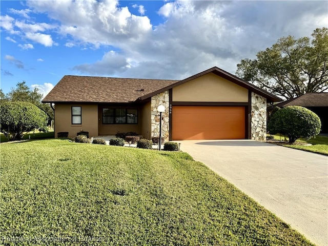 single story home featuring a garage and a front lawn