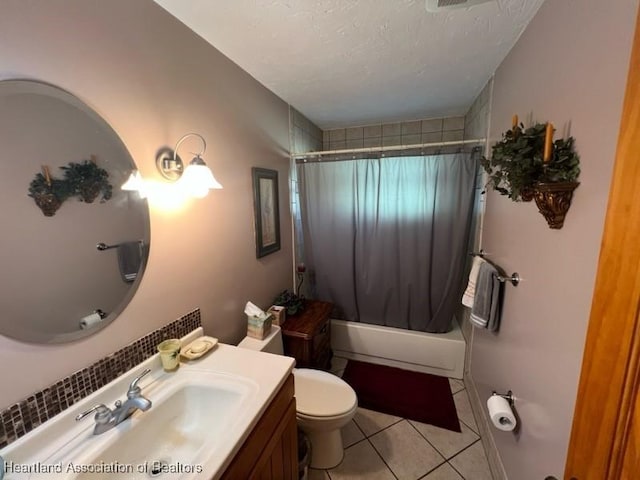 full bathroom with tile patterned floors, a textured ceiling, toilet, shower / bath combo with shower curtain, and vanity