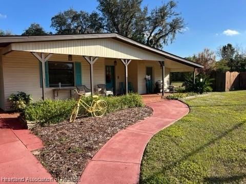 view of front of property with a front lawn and covered porch