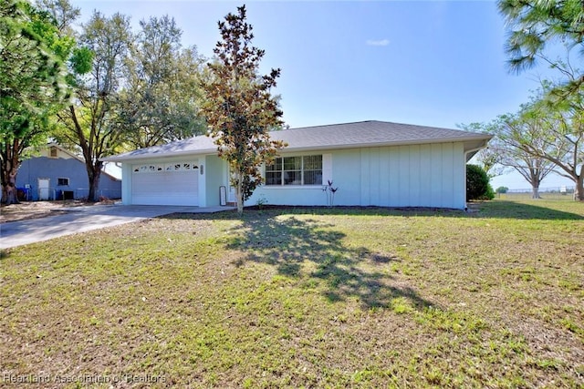 ranch-style home with a front lawn, concrete driveway, and a garage