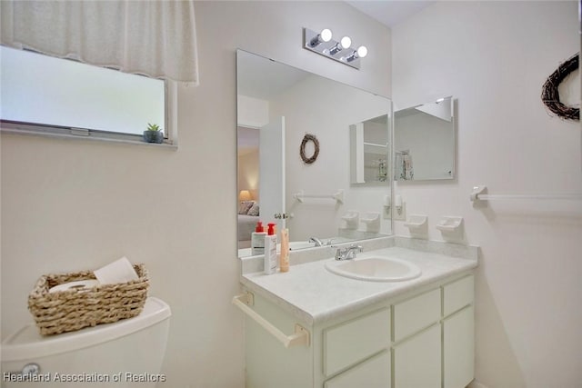 bathroom featuring toilet and vanity