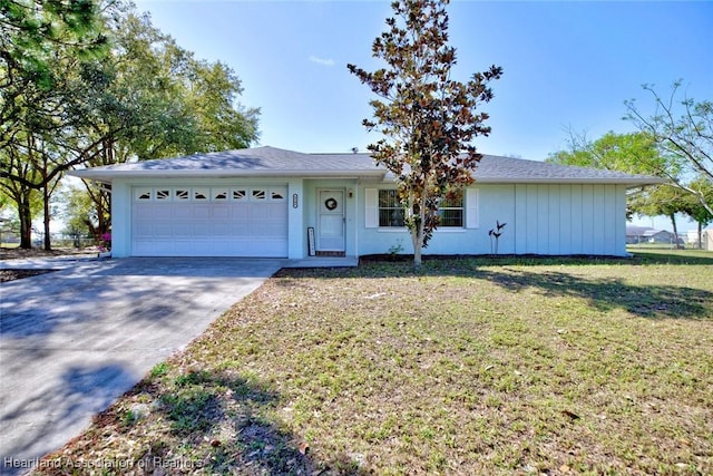 single story home with concrete driveway, a front lawn, and an attached garage