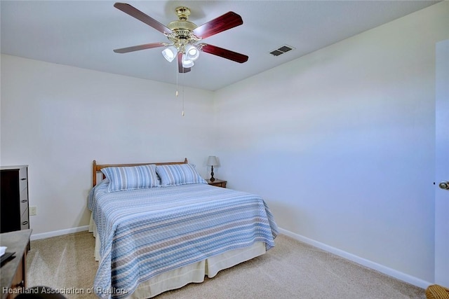 carpeted bedroom with visible vents, ceiling fan, and baseboards