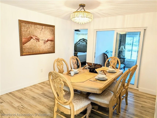 dining room featuring a chandelier and light hardwood / wood-style flooring