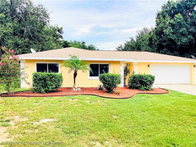 single story home featuring a garage and a front lawn