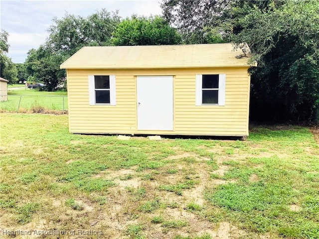 view of outdoor structure featuring a lawn