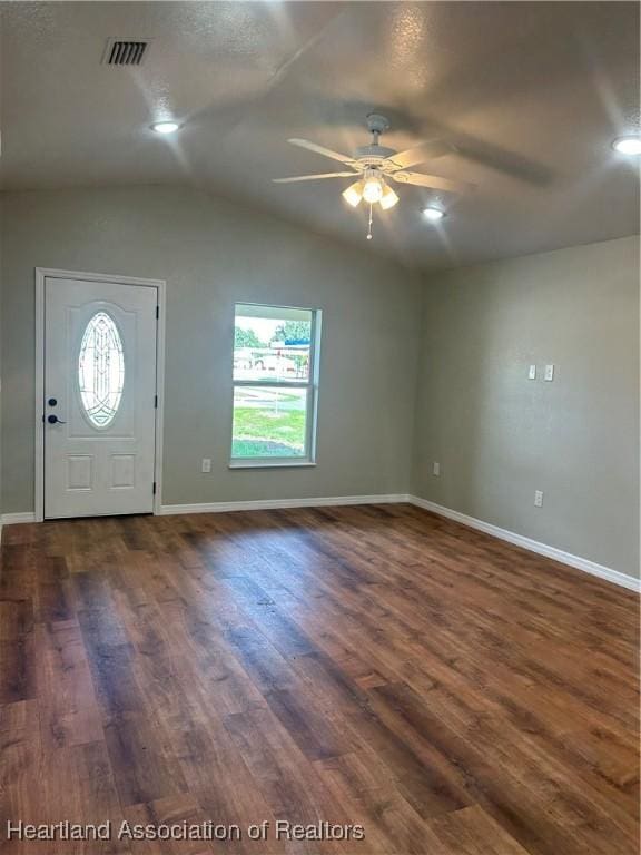 foyer entrance with plenty of natural light, vaulted ceiling, ceiling fan, and dark hardwood / wood-style flooring