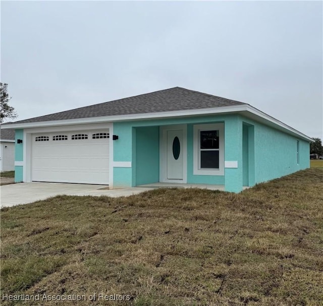 single story home with a garage and a front yard