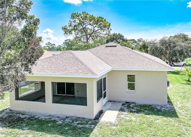 4021 Page Ave, Sebring, FL 33875 - rear view of house featuring a shingled roof, a yard, and stucco siding