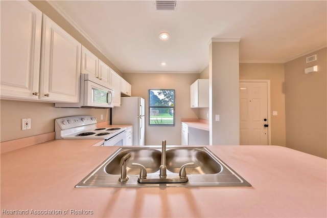 4021 Page Ave, Sebring, FL 33875 - kitchen with white appliances, light countertops, white cabinetry, crown molding, and recessed lighting