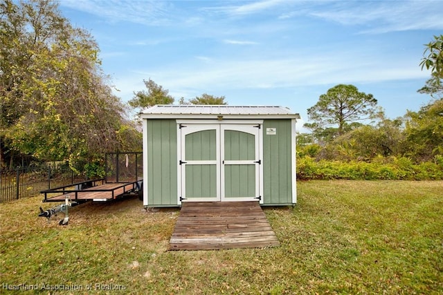 view of outbuilding featuring a yard