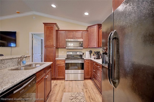 kitchen with lofted ceiling, sink, ornamental molding, and black appliances