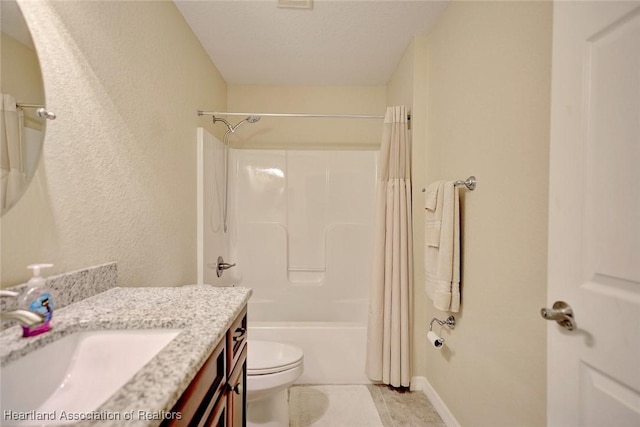 full bathroom with vanity, shower / tub combo with curtain, and toilet