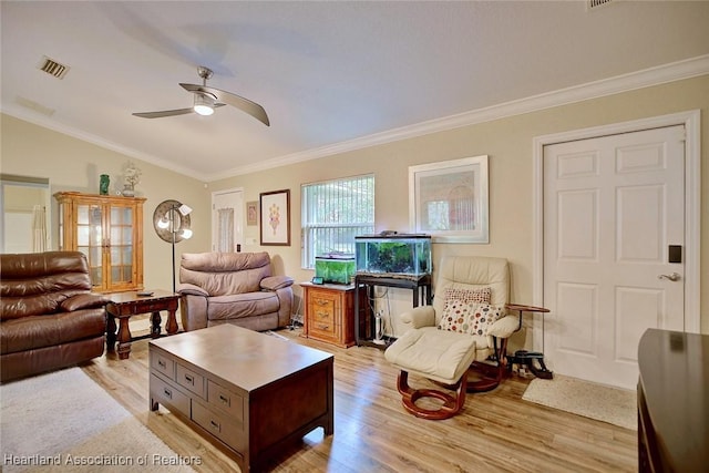 living room featuring crown molding, lofted ceiling, and light hardwood / wood-style floors