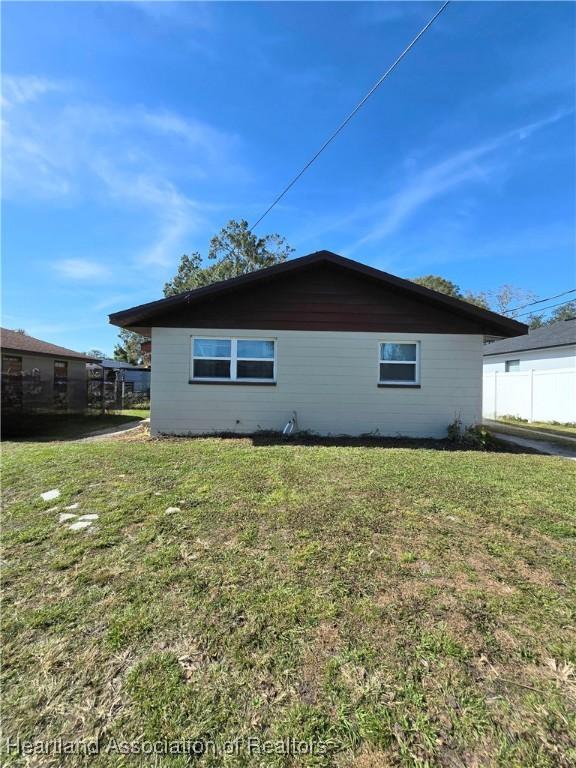 view of side of home with a lawn