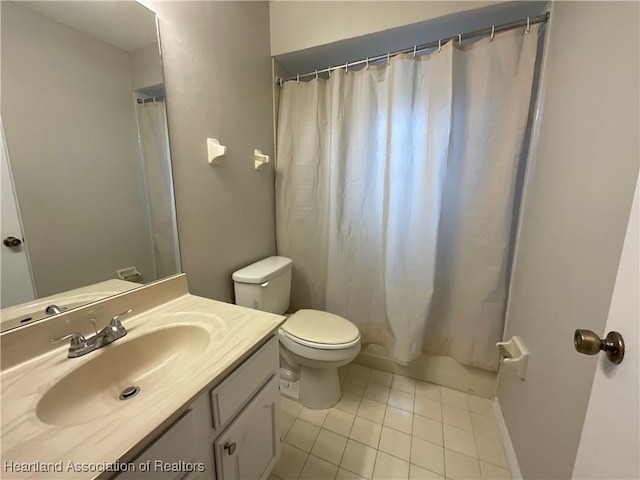 bathroom featuring tile patterned flooring, toilet, vanity, and a shower with curtain