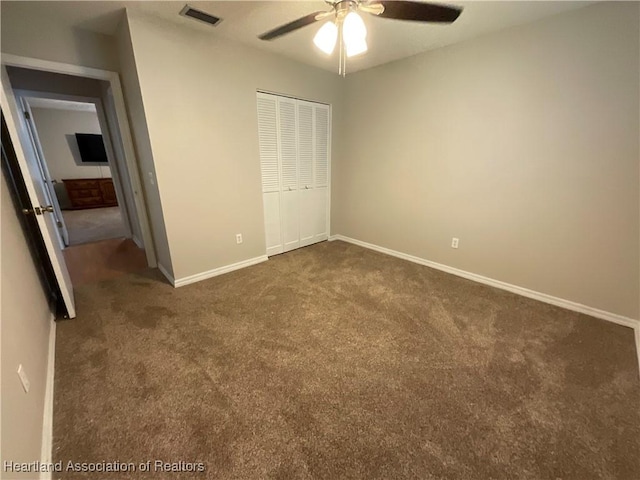 unfurnished bedroom featuring carpet, baseboards, a closet, and ceiling fan