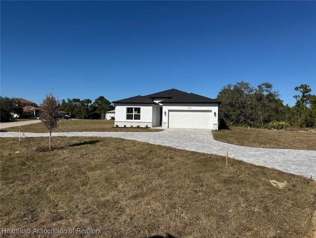 view of front of house with a front yard and a garage