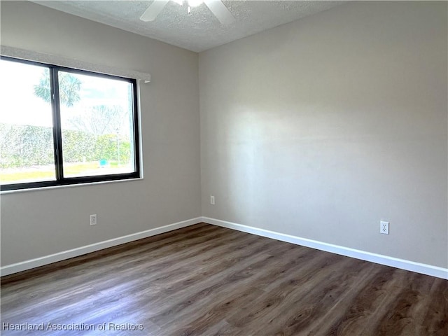 spare room featuring ceiling fan, a textured ceiling, baseboards, and wood finished floors