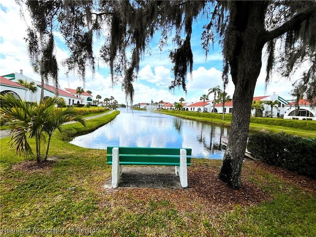 view of community with a water view and a lawn