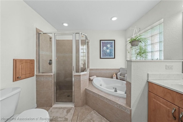 bathroom featuring toilet, a stall shower, a garden tub, and vanity