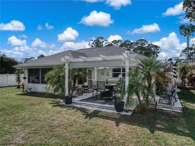 rear view of house featuring a shingled roof, fence, a yard, a patio area, and a pergola