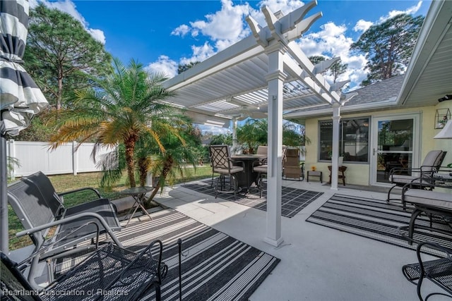 view of patio featuring fence, outdoor dining area, and a pergola