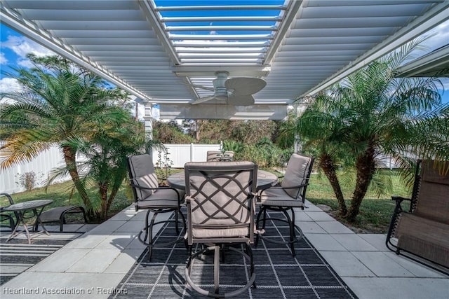 view of patio with fence private yard, ceiling fan, a pergola, and outdoor dining space