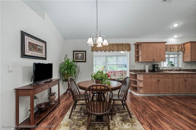 dining space featuring a chandelier, recessed lighting, dark wood-style flooring, and vaulted ceiling