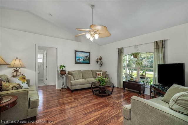 living area with a ceiling fan, vaulted ceiling, and wood finished floors