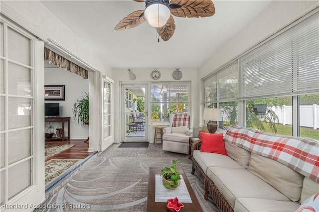 sunroom featuring a ceiling fan and a wealth of natural light