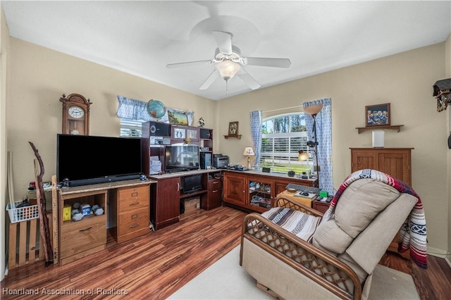 office with a ceiling fan and wood finished floors