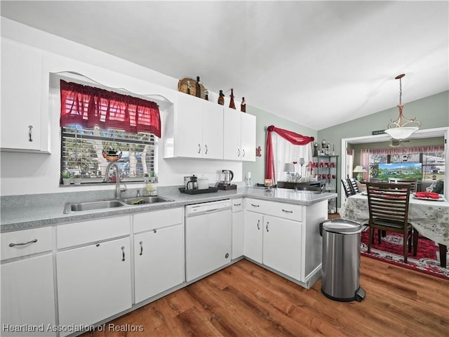 kitchen featuring white dishwasher, white cabinetry, lofted ceiling, and sink