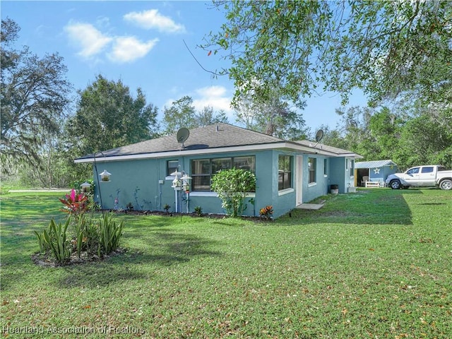 rear view of property with a lawn