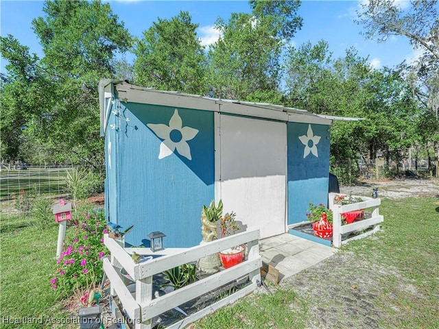 view of outbuilding featuring a lawn