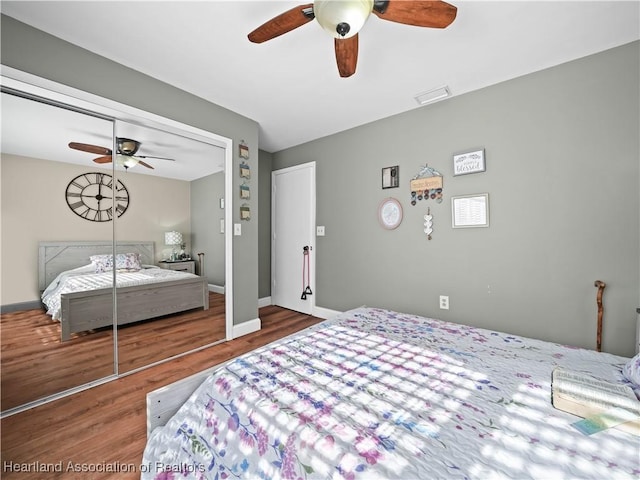 bedroom featuring hardwood / wood-style flooring, a closet, and ceiling fan