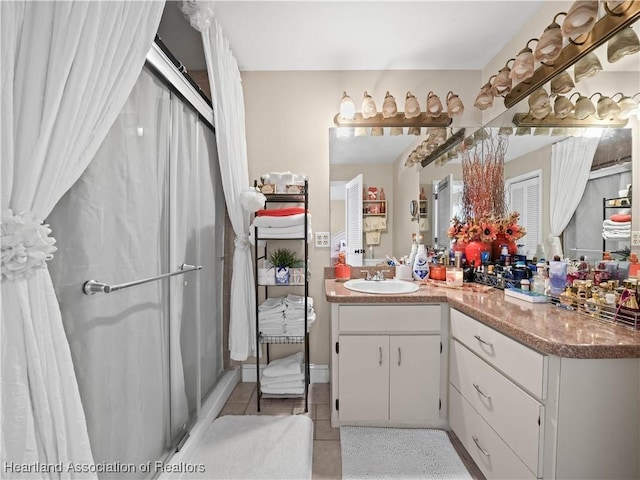 bathroom featuring tile patterned flooring and vanity