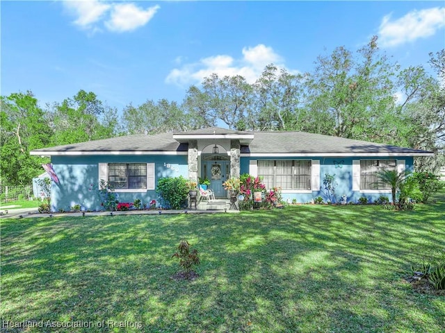 ranch-style home with a front lawn