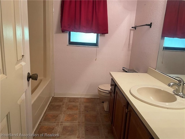 16 Notre Dame St, Lake Placid, FL 33852 - bathroom with vanity, baseboards, a textured wall, and toilet