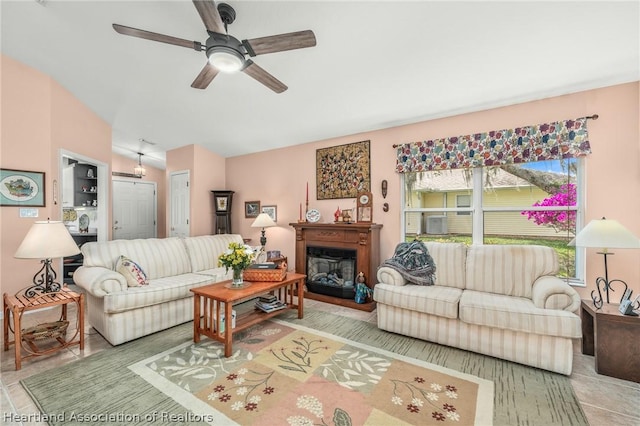 living room featuring tile patterned floors and ceiling fan