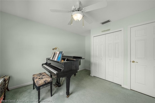 misc room featuring light colored carpet and ceiling fan