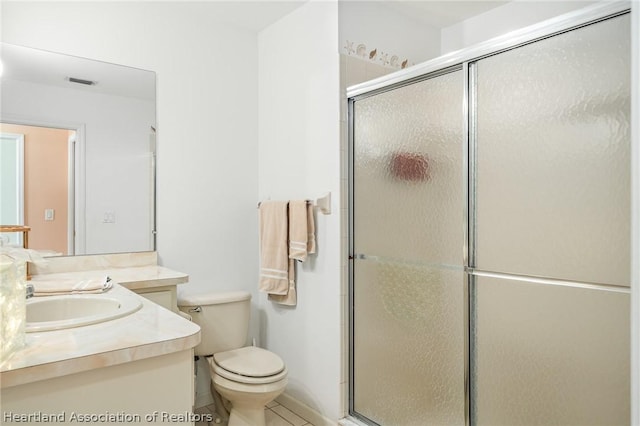 bathroom featuring vanity, toilet, and walk in shower