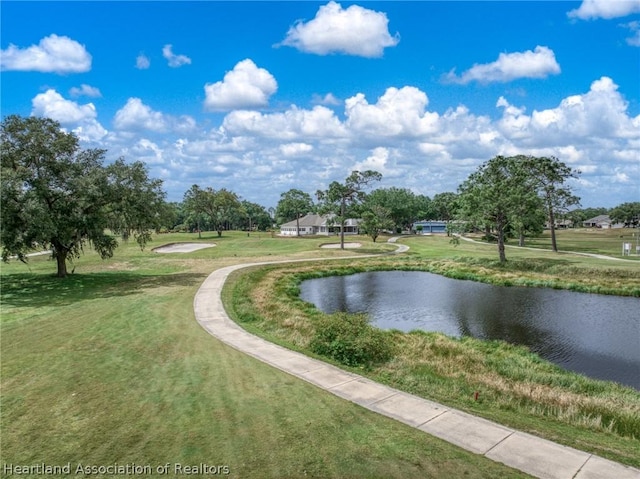 view of home's community with a yard and a water view