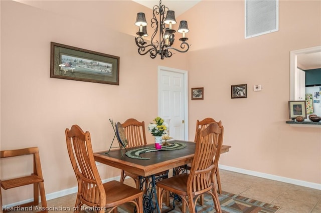 tiled dining area featuring an inviting chandelier