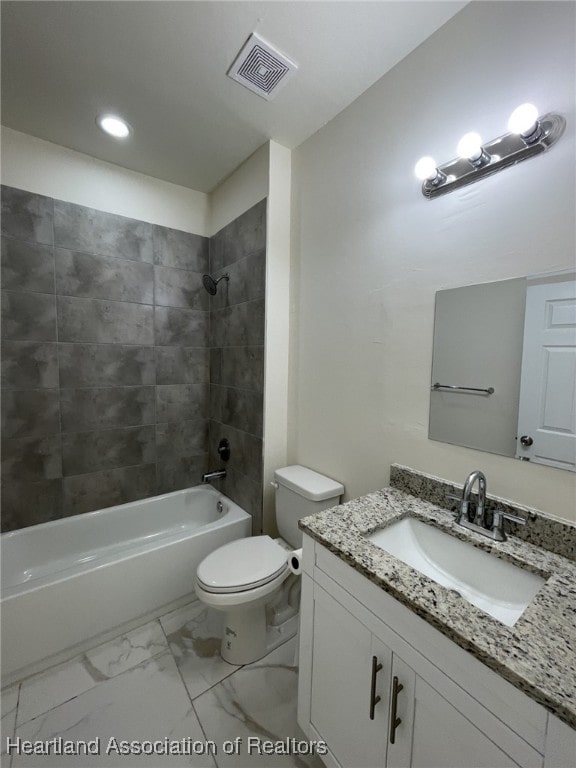 full bathroom with vanity, tiled shower / bath combo, and toilet